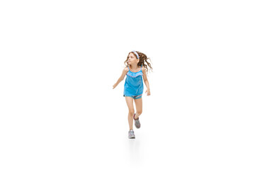 Happy kids, little and emotional caucasian girl jumping and running isolated on white background. Look happy, cheerful, sincere. Copyspace for ad. Childhood, education, happiness concept.