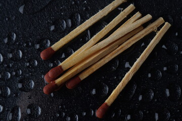 Matches on Dark background with water drops 