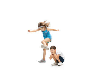 Fototapeta na wymiar Happy kids, little and emotional caucasian boy and girl jumping and running isolated on white background. Look happy, cheerful, sincere. Copyspace for ad. Childhood, education, happiness concept.