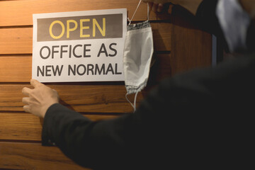 Business owner wears masks to label for open office. The concept is opening office after the...
