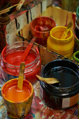 multicolored gouache paints in jars in close up