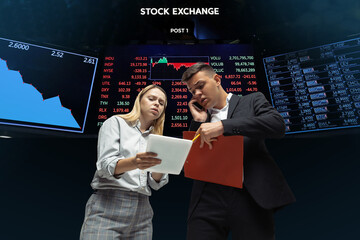 Intense. Nervous tensioned investors analyzing crisis stock market with charts of falling stock...
