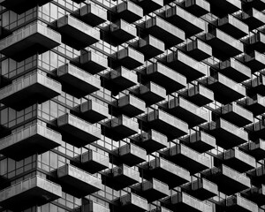Fototapeta premium Abstract Architectural Background. Black and White Balconies on Modern Office Building.