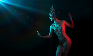 Fototapeta na wymiar Indian goddess illuminated by blue flare and red light on black background