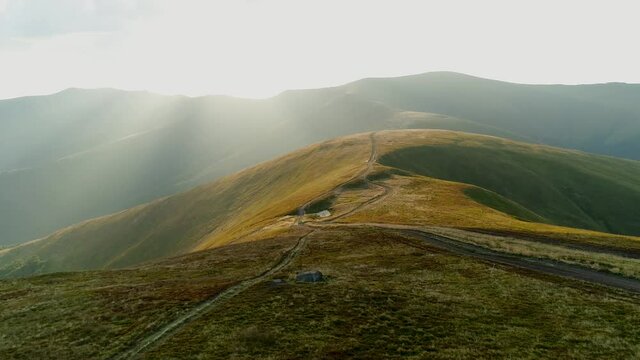 The car carries tourists. Moves off-road on tops of mountains of the Ukrainian Carpathians. Mount Gemba. Aerial view.