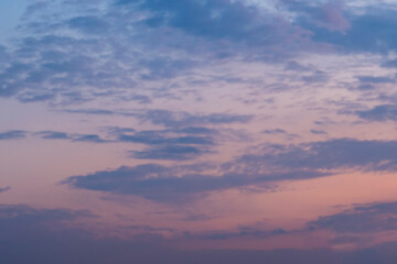 Pinky sunset sky with soft gray or blue clouds. Background image.