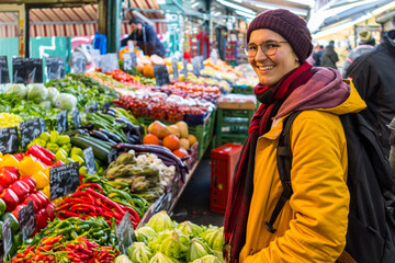 Young women in a market looking around.