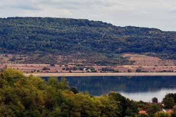 Fototapeta na wymiar forest reflected in the lake in autumn season