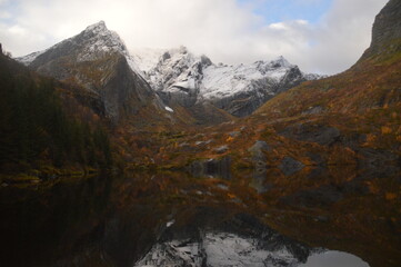 Fototapeta na wymiar Autumn colors and reflections in the Norwegian fjords and mountains over Lofoten, Norway