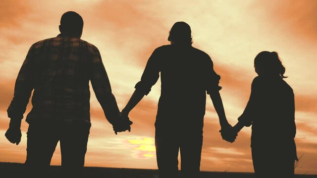 teamwork. team community hold hands together silhouette at sunset unity. group of people hands. teamwork workers carry out one mission go to the goal . business lifestyle team in the company working