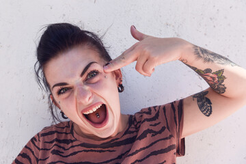 donna pazza simpatica sguardo pazzo punk rock modella punk pistola pazzia matta ragazza tatuaggi 