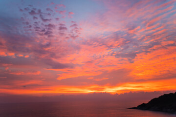 Colourful sunset sky on seashore beach wave Phuket