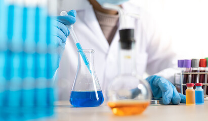 Doctor is testing a vaccine against the virus in the lab.