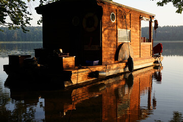 Wooden houseboat at sunrise at Mecklenburger lake district         