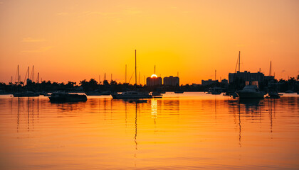 Fototapeta na wymiar sunrise at the marina florida sun summer boat sea ocean reflection 