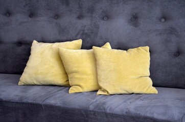 gray sofa with yellow brown pillows
