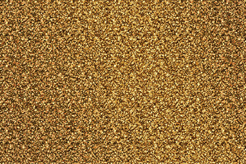 Luxury gold glitter texture with bright sparkles and flickers on the white isolated background. Shiny glamour background.