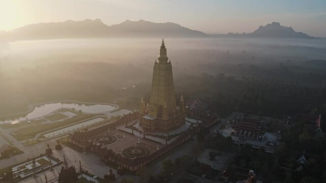 Drone aerial shot of sunrise over Wat Mahathat Watchiramongkhon (Wat Bang Thong) in Krabi, Thailand