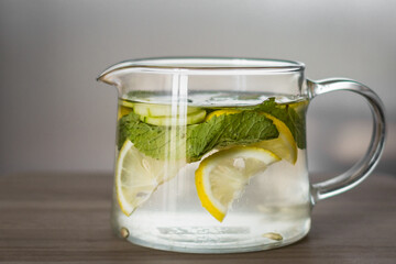 Sassi water. How much to drink. Diet drink. Water with lemon, cucumber, mint and ginger. Slimming vitamin cocktail. How to lose weight. Liquid vitamins. Citrus freshness. Fruit slices.