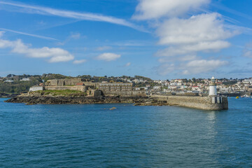 Fototapeta na wymiar View from sea of Castle Cornet. Castle Cornet has guarded Saint Peter Port for 800 years. Saint Peter Port - capital of Guernsey, British Crown dependency in English Channel off coast of Normandy.
