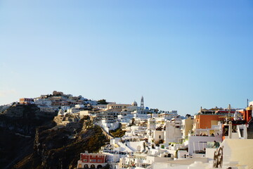 The sunset into the sea, seeing from beautiful city, Thira, Greece, Europe