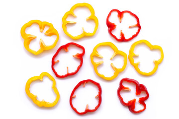 Slices of red and yellow bell peppers or capsicum seamless pattern texture on white background. Top...