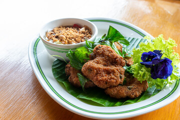 Fried Fish-Paste Balls with fresh vegetable on wooden table. Thai Traditional Foods.