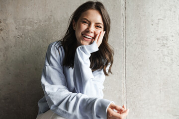 Image of charming joyful woman smiling and looking at camera © Drobot Dean