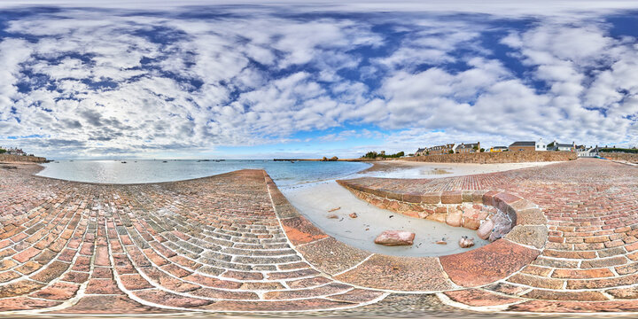 360 by 180 degree equirectangular image of La Rocque, Grouville, Jersey, Channel Islands with the beach, harbour from the East Slip on a broken cloudy day. VR