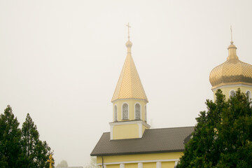 Orthodox church with golden domes on a cloudy day close-up. Religion concept