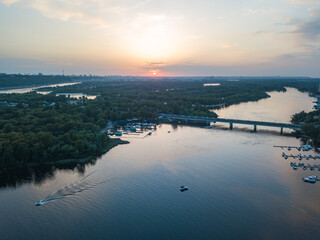Fototapeta premium Sunset over the Dnieper River in Kiev. Aerial drone view.