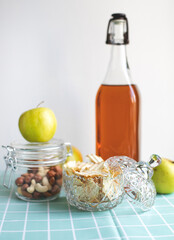 Delicious organic apples for breakfast. Nuts, dried apples, apple chips, freshly squeezed fruit juice on a turquoise background.
