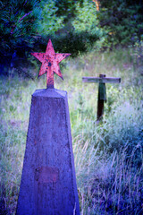 Grave crosses and tombstones stand in the old cemetery in Russia