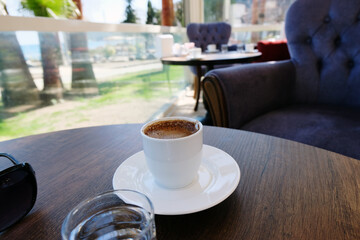 a cup of coffee in a cafe by the sea