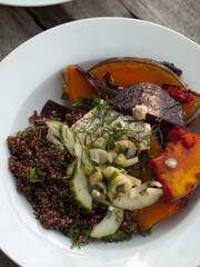 Wholefoods pumpkin and quinoa dish on wooden table