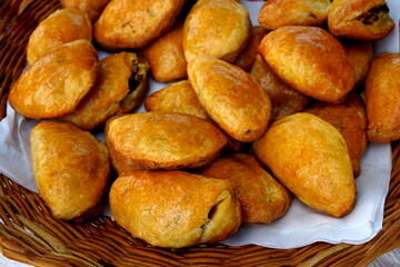 traditional home baked bacon and lard patty from a yeast dough. Home baked pies filled with smoked bacon. Traditional latvian kitchen recipe