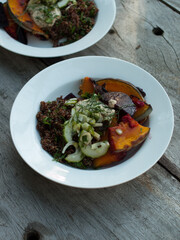 Wholefoods pumpkin and quinoa dish on wooden table