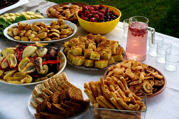 Traditional midsummer festive table with pies, cakes, lemonades and grilled vegetables, Midsummer food table in Latvia