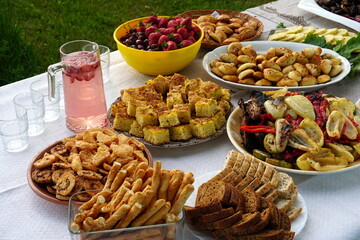 Traditional midsummer festive table with pies, cakes, lemonades and grilled vegetables, Midsummer food table in Latvia © Art Johnson