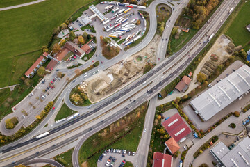 Top down aerial view of freeway interstate road with moving traffic cars in rural area.