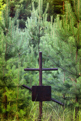 Grave crosses and tombstones stand in the old cemetery in Russia