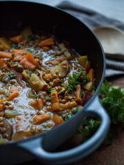 Rustic carrot and lentil curry in pot