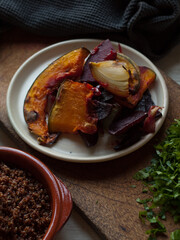Rustic roast pumpkin slices on wooden board