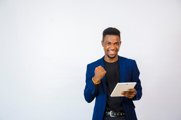 a young handsome african businessman isolated over white background feeling excited about what he...