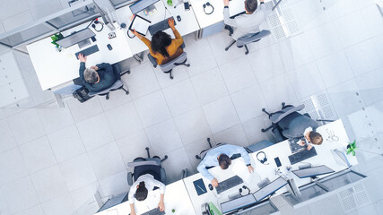 Top Down Shot of Big Busy Corporate Office with Tow Rows off Businessmen and Businesswomen Working on Desktop Computers. Bright Open Space Office with Businesspeople and Salespeople