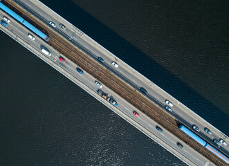 Aerial drone top view. Kiev metro trains travel across the bridge over the Dnieper River. Clear...