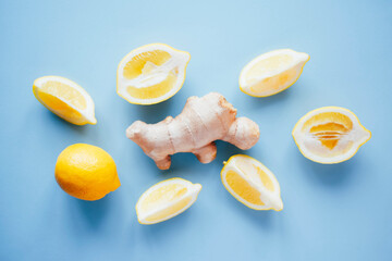 Ginger and fresh lemons on a blue background.
