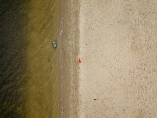 Aerial drone view. A boat on an empty sandy beach on the Dnieper River in Kiev.