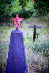 Grave crosses and tombstones stand in the old cemetery in Russia