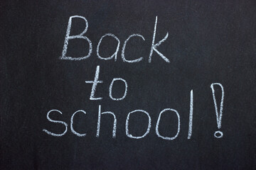 
Lettering on the chalk board "back to school". Approaching the next school year after the period of the pandemic